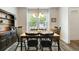 Bright dining area with large windows, wood floors, and black chairs around a wooden table at 3061 Cross Vine Ln, Summerville, SC 29483