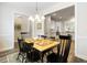 Traditional dining room featuring a wooden table, six chairs, and a decorative chandelier at 3061 Cross Vine Ln, Summerville, SC 29483