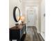 Stylish entryway featuring dark wood floors, decorative console table, mirror, and modern lighting fixture at 3061 Cross Vine Ln, Summerville, SC 29483