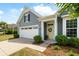 Beautiful home with a two-car garage, well-manicured landscaping, and inviting front entrance with wreath at 3061 Cross Vine Ln, Summerville, SC 29483