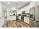 Bright kitchen with stainless steel appliances, white cabinets, granite countertops, and wood-look flooring at 3061 Cross Vine Ln, Summerville, SC 29483