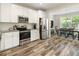Well-designed kitchen featuring stainless steel appliances, white cabinetry, and an open layout at 3061 Cross Vine Ln, Summerville, SC 29483