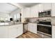 Beautiful kitchen with granite counters, stainless steel appliances, white cabinets, and wood-look flooring at 3061 Cross Vine Ln, Summerville, SC 29483