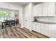 Spacious kitchen with white cabinets, stainless steel appliances, granite countertops and wood floors at 3061 Cross Vine Ln, Summerville, SC 29483