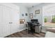 Well-lit home office with dual monitors, shelving, and a comfortable chair for an optimal work-from-home experience at 3061 Cross Vine Ln, Summerville, SC 29483