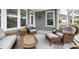 Charming screened porch with wicker furniture, creating a serene outdoor living space at 3061 Cross Vine Ln, Summerville, SC 29483