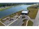 Aerial view of community amenities, including a pool, playground, parking, and lake at 312 Cypress Branch Rd, Huger, SC 29450