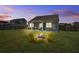 Relaxing backyard featuring a stone fire pit and screened-in patio at 312 Cypress Branch Rd, Huger, SC 29450
