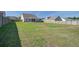 Large, open backyard with green grass and a wood privacy fence at 312 Cypress Branch Rd, Huger, SC 29450