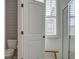 Bathroom with a white toilet and a shower behind a glass door, brightened by natural light at 312 Cypress Branch Rd, Huger, SC 29450