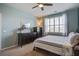 Bright bedroom featuring a ceiling fan, stylish dressers, and a window with plantation shutters at 312 Cypress Branch Rd, Huger, SC 29450