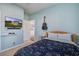 Bedroom featuring a guitar, light blue walls, and a TV mounted on the wall at 312 Cypress Branch Rd, Huger, SC 29450