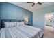 Bedroom boasts stylish blue accent wall and a ceiling fan; bathroom entrance visible at 312 Cypress Branch Rd, Huger, SC 29450