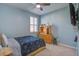 Bedroom with light blue walls, a ceiling fan and a dark wood dresser at 312 Cypress Branch Rd, Huger, SC 29450