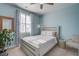 Cozy bedroom features a neutral palette, a ceiling fan, and large window with plantation shutters at 312 Cypress Branch Rd, Huger, SC 29450
