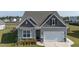 Charming single-Gathering home featuring a two-car garage and neutral siding at 312 Cypress Branch Rd, Huger, SC 29450