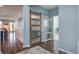 Inviting hallway features wood floors, a modern barn door, and views to a bright living area at 312 Cypress Branch Rd, Huger, SC 29450