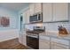 Well-equipped kitchen with stainless steel appliances, granite countertops, and white subway tile backsplash at 312 Cypress Branch Rd, Huger, SC 29450