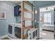 Stylish laundry room with a sliding barn door, upper cabinets, and modern washer and dryer at 312 Cypress Branch Rd, Huger, SC 29450