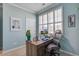 Bright office with a wooden desk, comfortable chair, and a window with plantation shutters at 312 Cypress Branch Rd, Huger, SC 29450