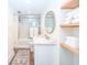 Bright bathroom with large mirror, standup shower and floating wooden shelves with towels at 330 Concord St # 4A, Charleston, SC 29401