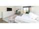 Bedroom with tv and desk, with a queen bed with a patterned rug underfoot at 330 Concord St # 4A, Charleston, SC 29401