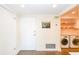 Entryway with front door and stacked laundry, featuring painting of city and warm lighting at 330 Concord St # 4A, Charleston, SC 29401