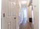Hallway with wood-look floors and white doors leading to various rooms at 333 Flyway Rd, Goose Creek, SC 29445