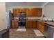 Kitchen boasts stainless steel appliances, wood cabinets, modern hardware and wood flooring at 333 Flyway Rd, Goose Creek, SC 29445