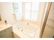 Bright bathroom featuring a tub next to a window with white blinds at 3439 Toomer Kiln Cir, Mount Pleasant, SC 29466