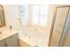 Bright bathroom features a soaking tub with jets, large window, and walk-in shower at 3439 Toomer Kiln Cir, Mount Pleasant, SC 29466