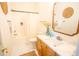 Bathroom with white hexagon tile, tub, and vanity with marble countertop and wood cabinets at 3439 Toomer Kiln Cir, Mount Pleasant, SC 29466