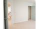 A doorway reveals an additional room and the neutral carpet and wall colors give this room an open feel at 3439 Toomer Kiln Cir, Mount Pleasant, SC 29466