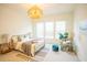 Well-lit bedroom with a decorative light fixture, a decorative bed frame, and neutral decor at 3439 Toomer Kiln Cir, Mount Pleasant, SC 29466