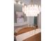 Chandelier hanging above a dining room table with a table runner and decor at 3439 Toomer Kiln Cir, Mount Pleasant, SC 29466