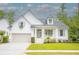Charming white two-story home with inviting front porch and well-manicured lawn at 3439 Toomer Kiln Cir, Mount Pleasant, SC 29466