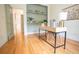 Charming home office with built-in shelving, hardwood floors, stylish desk and ample natural light at 3439 Toomer Kiln Cir, Mount Pleasant, SC 29466