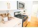 Modern kitchen with stainless steel appliances and sleek white cabinetry at 3439 Toomer Kiln Cir, Mount Pleasant, SC 29466