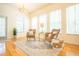 Bright living room with wicker chairs, many windows, and hardwood floors at 3439 Toomer Kiln Cir, Mount Pleasant, SC 29466
