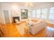 Spacious living room with wood floors, neutral furniture, a fireplace, and plenty of natural light from large windows at 3439 Toomer Kiln Cir, Mount Pleasant, SC 29466
