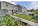 Spacious backyard with garden boxes, green grass, pergola, and privacy fence at 3990 Hillyard St, North Charleston, SC 29405