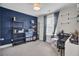 Bedroom with an accent wall, shelving, and a window offering natural light at 3990 Hillyard St, North Charleston, SC 29405