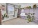 Decorated bedroom features desk, sewing machine, and houseplants displayed along a purple wood panel accent wall at 3990 Hillyard St, North Charleston, SC 29405