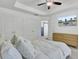 Bright bedroom features tray ceiling, fan, hard wood dresser, TV and a view to an ensuite bathroom at 3990 Hillyard St, North Charleston, SC 29405