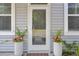Welcoming entrance framed by planters, offering a glimpse of the home's charm and curb appeal at 3990 Hillyard St, North Charleston, SC 29405