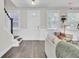 Inviting entryway with white wainscoting, wood floors, and a staircase leading to the upper level at 3990 Hillyard St, North Charleston, SC 29405
