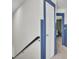 Hallway with neutral carpet, a door with blue trim, and a view of a bedroom at 3990 Hillyard St, North Charleston, SC 29405