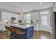 Modern kitchen with stainless steel appliances, white cabinets, a large island, and stylish pendant lights at 3990 Hillyard St, North Charleston, SC 29405
