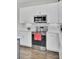Close-up of a kitchen with stainless steel oven and microwave with white cabinets and subway tile backsplash at 3990 Hillyard St, North Charleston, SC 29405