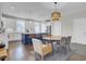 Open-concept kitchen and dining area with a large island, modern lighting, and hardwood floors at 3990 Hillyard St, North Charleston, SC 29405